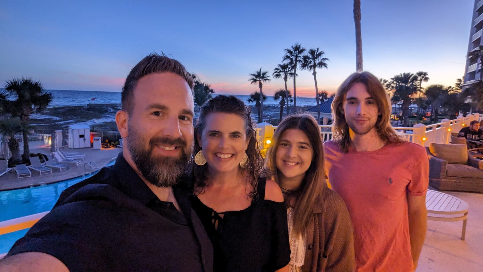 The Duncan family at sunset with palm trees